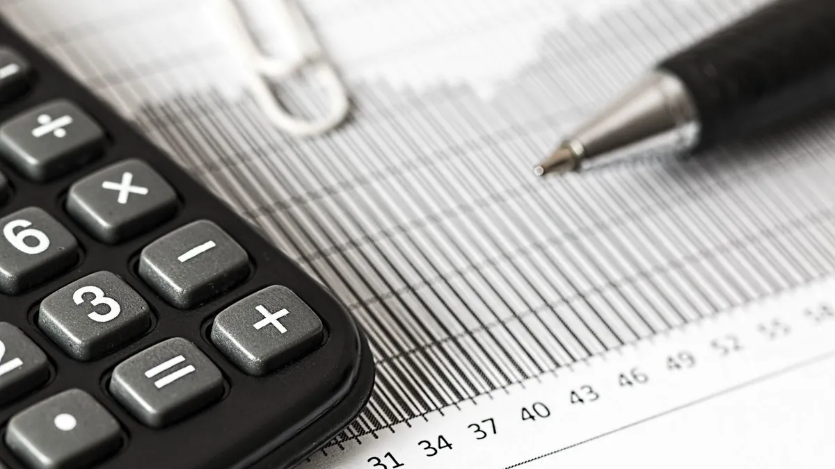 A calculator and a chart used to work out a grade point average